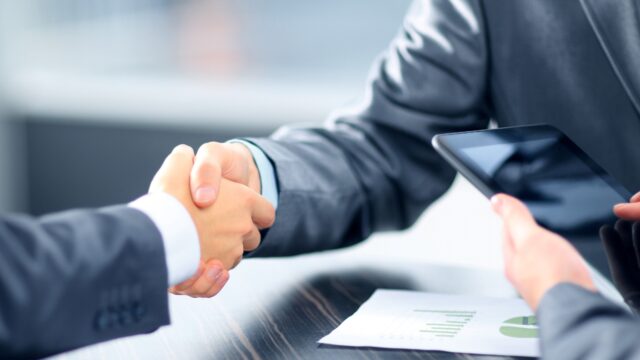 Business people shaking hands in office